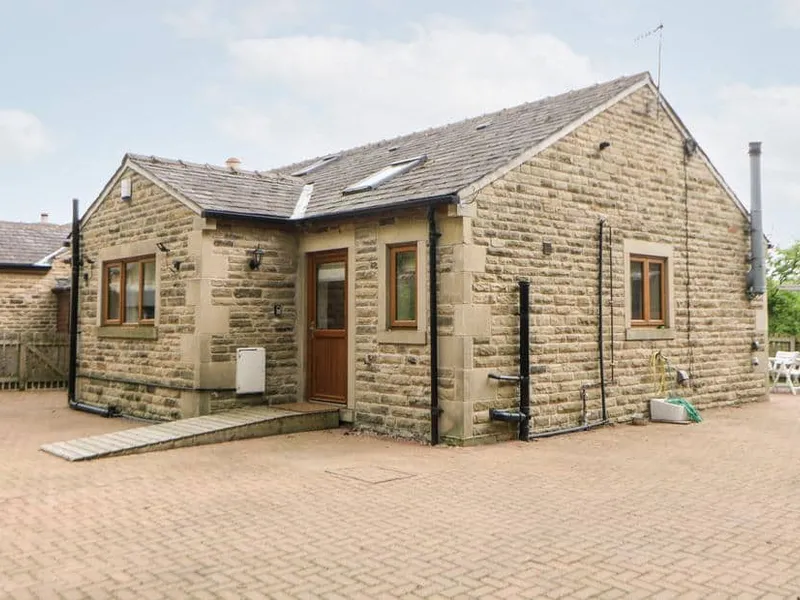 3 Pheasant Lane stone cottage with ramped entrance and paved courtyard