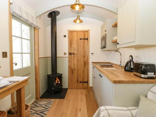 Cottage kitchen with wood burner and wooden worktops