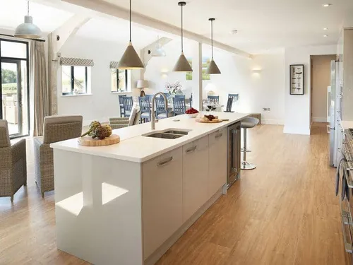 Cottage kitchen with central island, dining area and patio doors