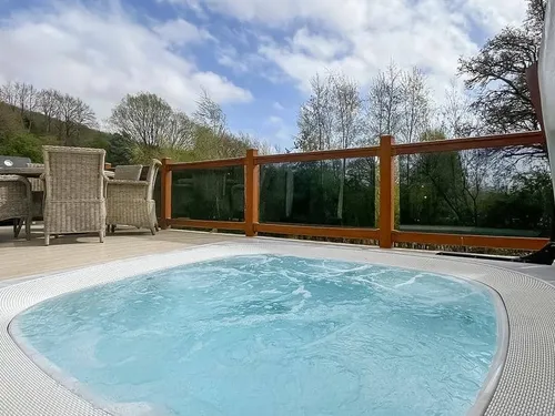 Lodge deck with hot tub and outdoor dining set