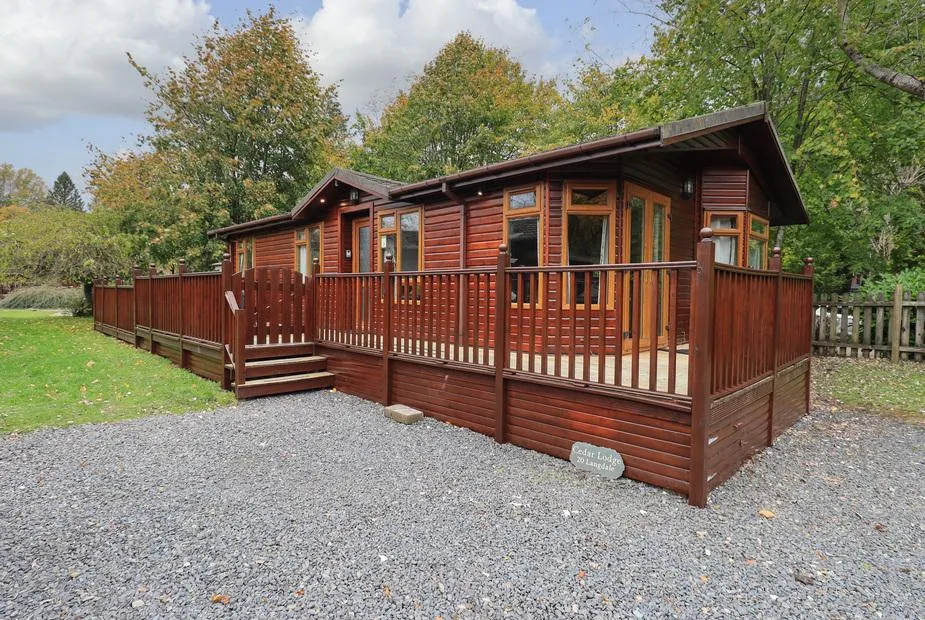 Cedar Lodge exterior with wraparound deck and surrounded by trees