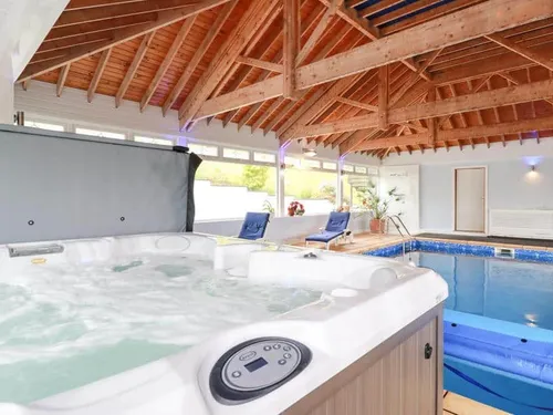 Cottage indoor pool room with hot tub and wooden vaulted ceiling