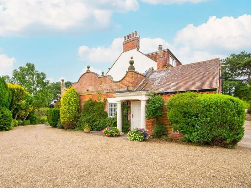 Church Beck House exterior with gravel driveway and surrounding greenery