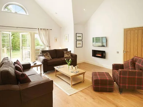 Lodge lounge with sofas, coffee table, and wall-mounted electric fire