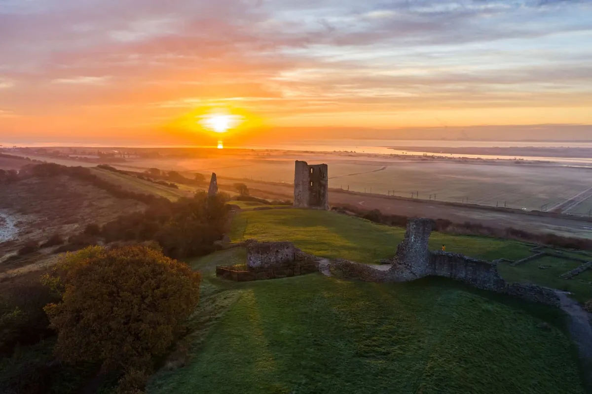 Sunrise illuminating the ruins of Hadleigh Castle overlooking the Thames Estuary and Essex countryside.