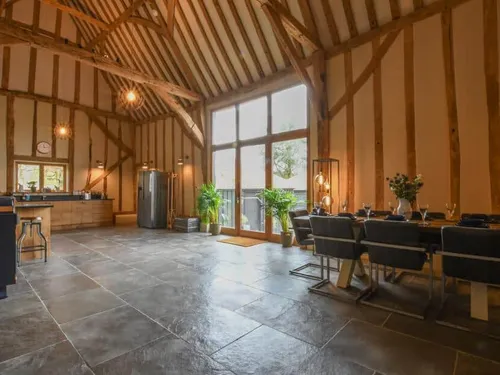 Cottage kitchen diner with exposed beams and large windows