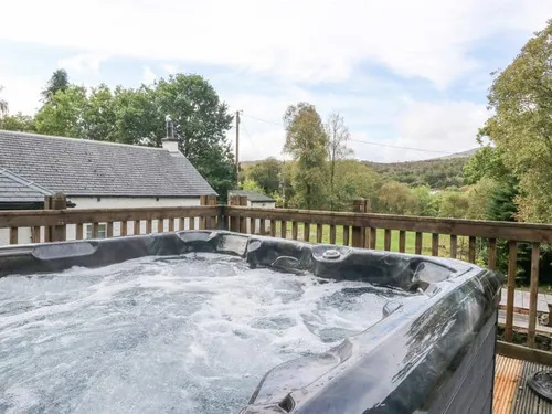 Cottage deck with bubbling hot tub and countryside views