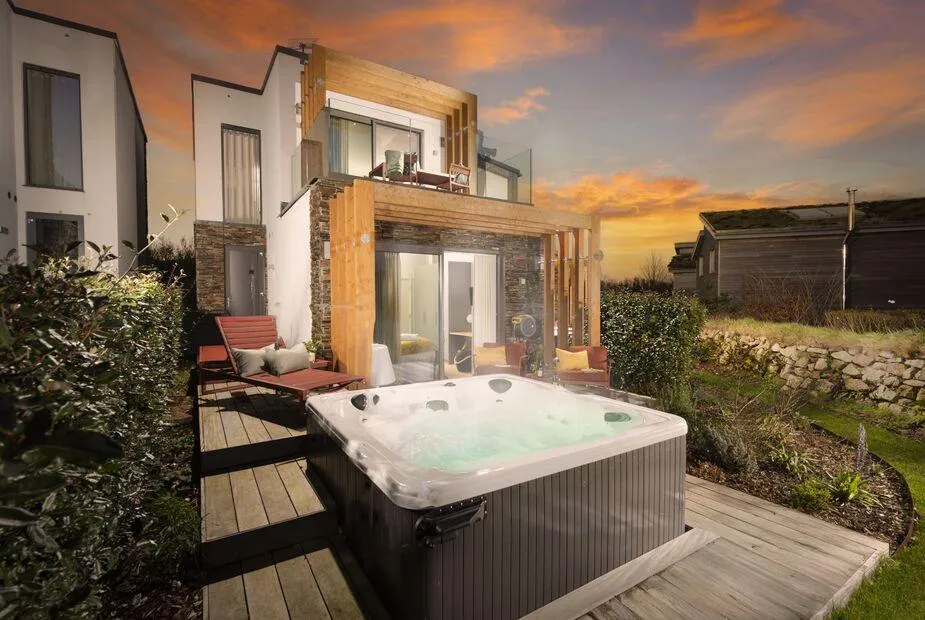 Lefransa lodge with outdoor hot tub and deck seating at sunset in Carbis Bay