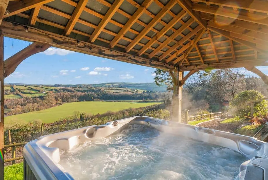 Hot tub under wooden gazebo at Little Silver Nugget with countryside views