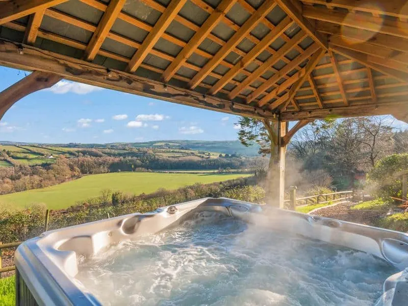 Hot tub under wooden gazebo at Little Silver Nugget with countryside views