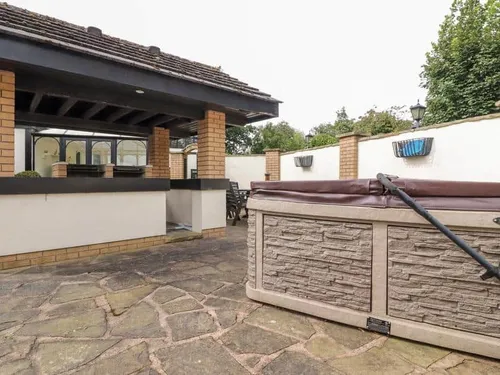 Cottage patio with hot tub and outdoor bar area