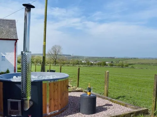 Cottage garden with wood-fired hot tub and countryside view