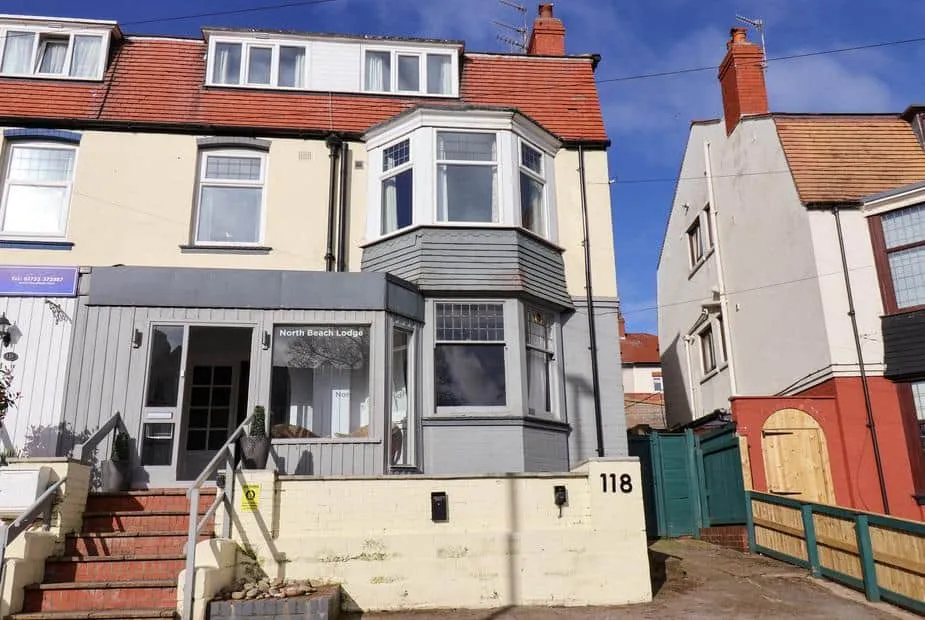 North Beach Lodge exterior with bay windows and front entrance steps