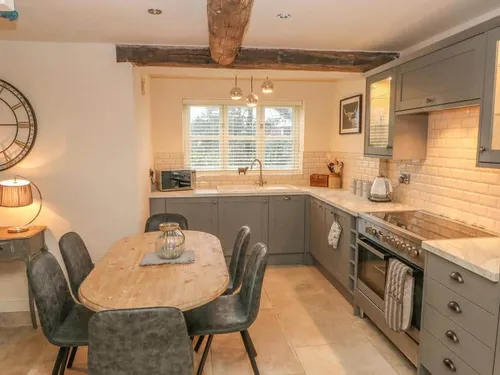 Kitchen with dining table and exposed ceiling beam