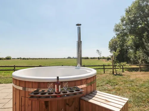 Lodge with outdoor hot tub and countryside view