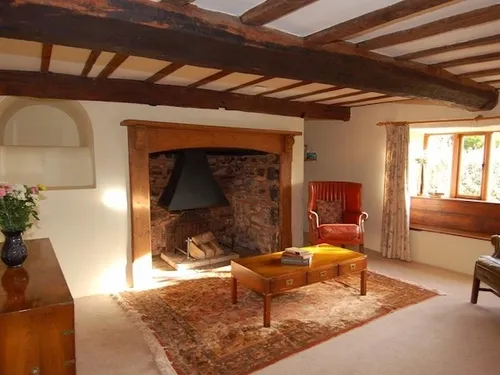 The living room showcases a fireplace and a beautiful wooden floor.