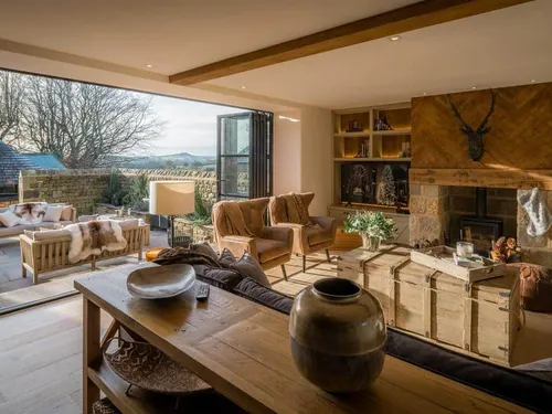 Living room with wood burner and open patio seating area