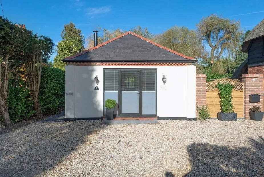 The Old Meeting Hall with gravel drive and central glass door entrance.