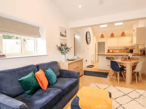 Cottage living room with sofa and open plan kitchen dining area