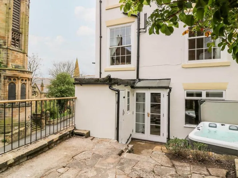 Trillo House courtyard with a hot tub beside stone patio