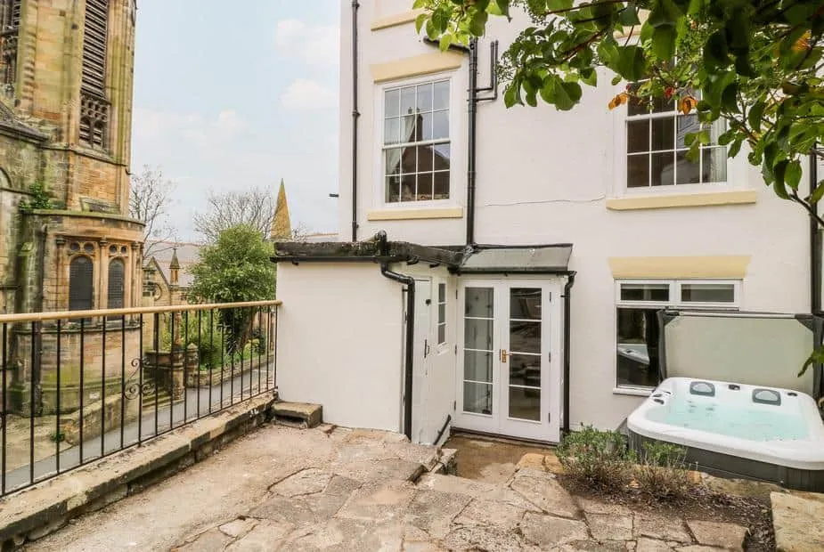 Trillo House courtyard with a hot tub beside stone patio