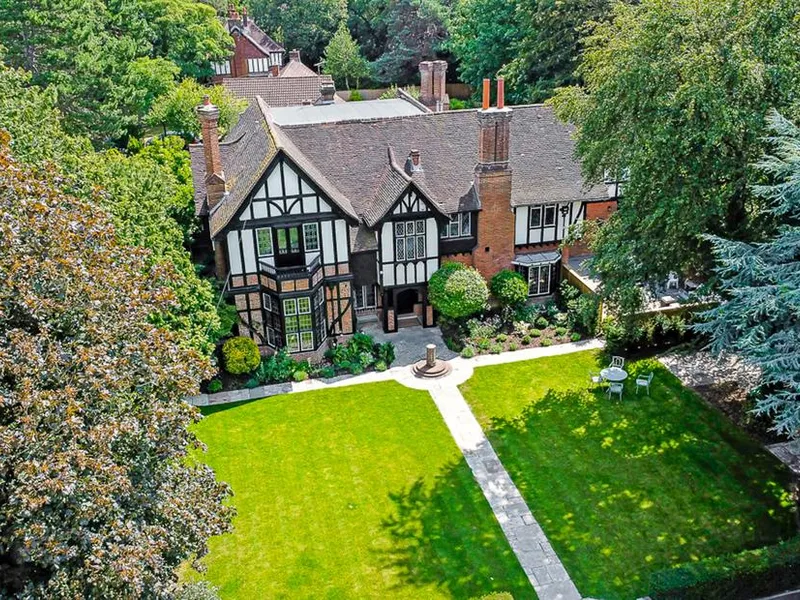 Tudor Grange with timber-framed exterior and large lawn garden with seating area