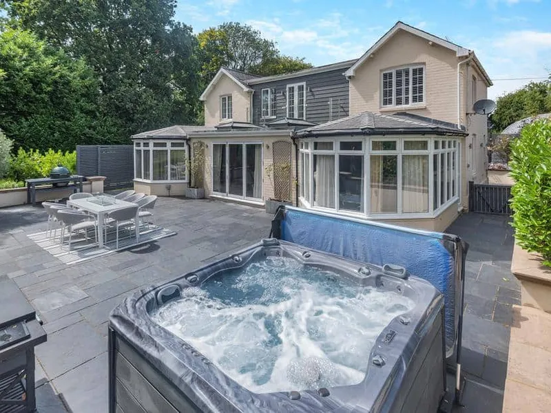 Woodlea Farm patio with hot tub, outdoor dining area, and conservatory visible