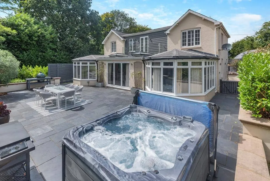 Woodlea Farm patio with hot tub, outdoor dining area, and conservatory visible